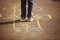 Kids playing hopscotch on playground outdoors. Hopscotch popular street game