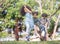 Kids playing jump over the rope in the park on sunny summer day.