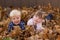 Kids playing in leaf pile leaves