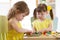 Kids playing with logical toy on desk in nursery room or kindergarten. Children arranging and sorting shapes, colors and