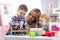 Kids playing with mother at table with educational toys. Toys for preschool and kindergarten. Children in nursery or