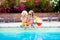 Kids playing at outdoor swimming pool