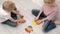 Kids playing with pop it sensory toy. boy and girl pressing on colorful rainbow squishy soft silicone bubbles. Stress