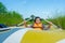 Kids playing and rowing boat in river of organic farm in rural on blue sky and white clouds background