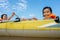 Kids playing and rowing boat in river of organic farm in rural on blue sky and white clouds background