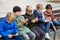 Kids playing with smartphones on bench