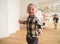 Kids playing in spacious light room. Cute blonde toddler boy running laughing and blurred girl near pink play kitchen eating