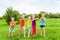 Kids playing with water guns on a meadow