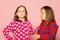 Kids pose on pink background. Girls in colorful bright pajamas