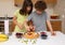 Kids preparing fruity cake