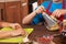 Kids preparing a pizza together - closeup on hands, shallow dept