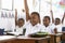 Kids raising hands during a lesson at an elementary school