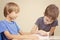 Kids reading a book. Little boy practice reading with his brother.