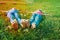 Kids relax in green grass, little girls feet with camomile in nature