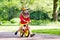 Kids ride balance bike in park