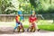 Kids ride balance bike in park