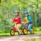 Kids ride balance bike in park