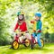 Kids ride balance bike in park