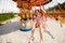 Kids riding on colorful amusement carousel