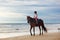Kids riding horse on beach. Children ride horses