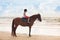 Kids riding horse on beach. Children ride horses