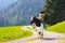 Kids riding pony. Child on horse in Alps mountains