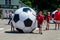 Kids rolling giant soccer balls