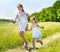 Kids running across green grass outdoor.