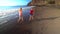 Kids running along the beach