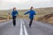 Kids running on an empty road in beautiful nature in Snaefellsjokull National Park in Iceland, autumntime