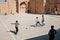 Kids running on football playground on Middle Eastern street