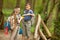 Kids scouts traveler with backpack hiking bridge in forest