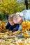 Kids searching amongst autumn leaves