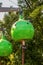 Kids shoes and dirty legs hang out of a lime green climbing pod with rope ladder at Gathering Place public park in Tulsa OK -