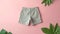 Kids shorts mockup. Top view children clothing isolated on pink background. Copy space. Flat lay. Banner. Comfortable wear for