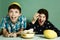 Kids siblings peeling grape fruit make funny hat