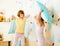 Kids sisters play with pillows in the bedroom