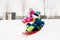 Kids sliding on sleds down snow hill in winter