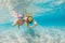 Kids in snorkeling mask dive underwater in blue sea lagoon