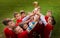 Kids soccer football - children players celebrating with a trop