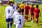 Kids soccer players entering pitch after referee in two rows. Youth football teams starting tournament match