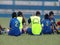 Kids soccer team sitting in field