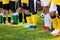 Kids on soccer training. Soccer players standing in a row. Low angle image of footballer`s legs in a sportswear and cleats