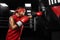 Kids sport concept. Girl sportsman muay thai boxer fighting in gloves in boxing gym.