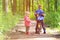 Kids sport - little boy and girl riding bikes in forest