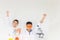 Kids or students scientist celebrates their success with raised arms in chemical tests laboratory, Children science concept