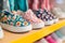 kids summer shoes with fun patterns on shelf