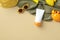 Kids sunscreen cream tube with sunglasses, panama hat, towel, sand molds on beige background