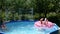 Kids swim and dive in outdoor swimming pool on sunny summer day, fun