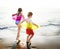 Kids with swim rings playing at the beach